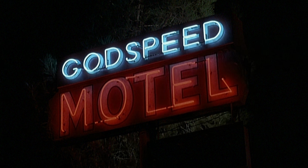 a neon sign that reads, god speed motel