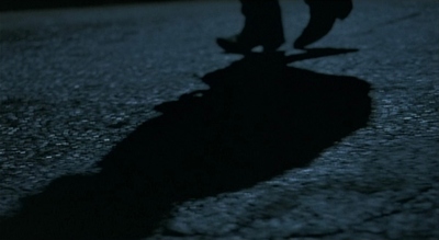 a shadow of a person riding a skateboard