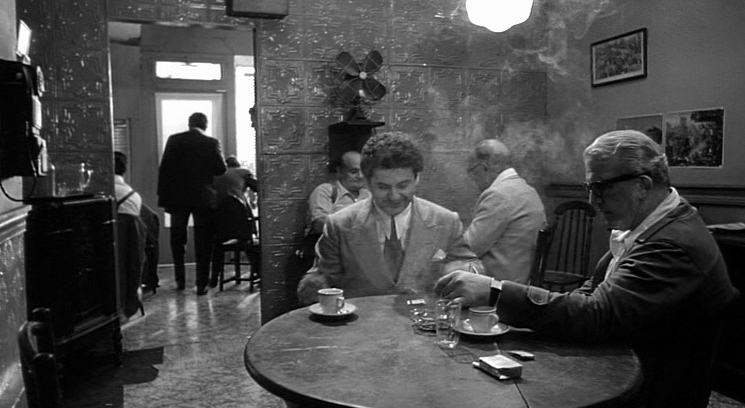 a group of men sitting at a table in a restaurant