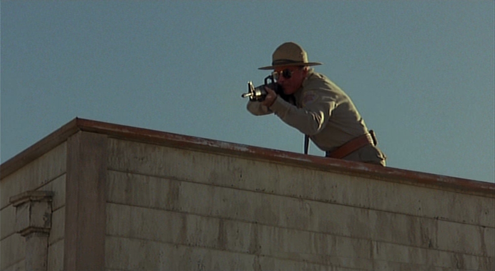 a man with a camera on top of a building