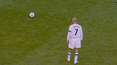 a man standing on top of a field next to a soccer ball