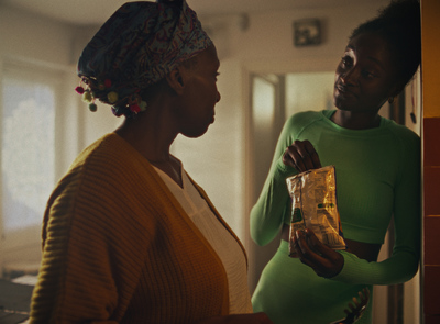 two women standing in a kitchen talking to each other