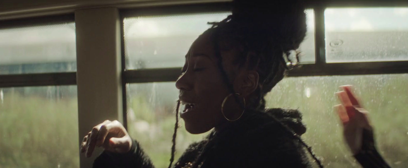 a woman standing in front of a window holding a cell phone