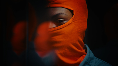 a person wearing a red mask and a blue jacket