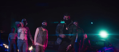 a group of people standing on a street at night