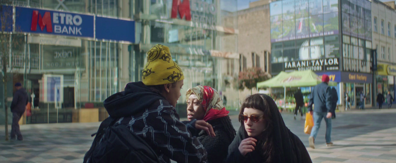 a group of people standing on a street corner