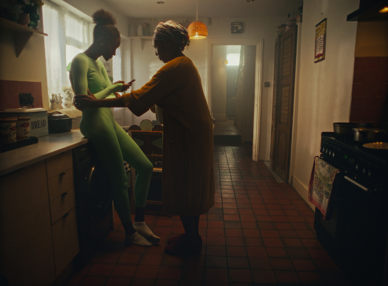 a couple of women standing next to each other in a kitchen