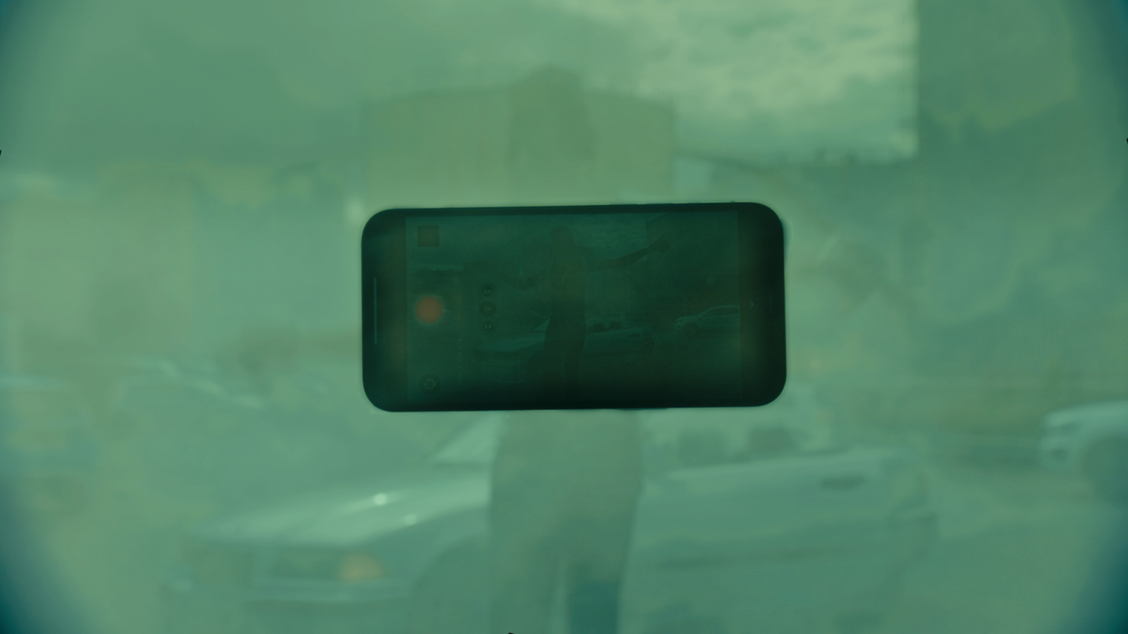 a blurry image of a person standing in front of a car