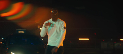 a man standing in front of a car at night