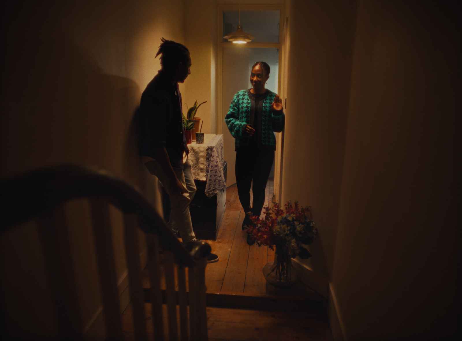 a couple of people standing in a hallway