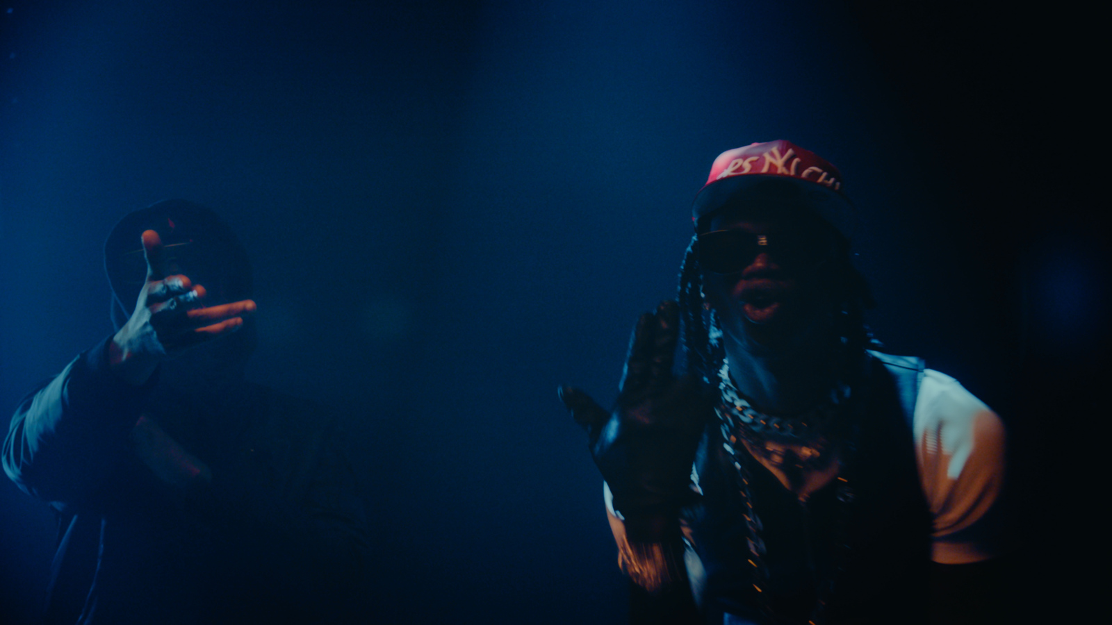 two people standing in front of a blue light