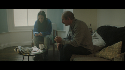 a man and a woman sitting in a living room