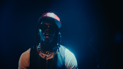 a man with dreadlocks and a hat on