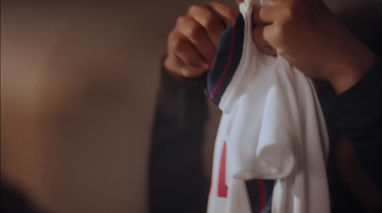 a person holding a white and red shirt