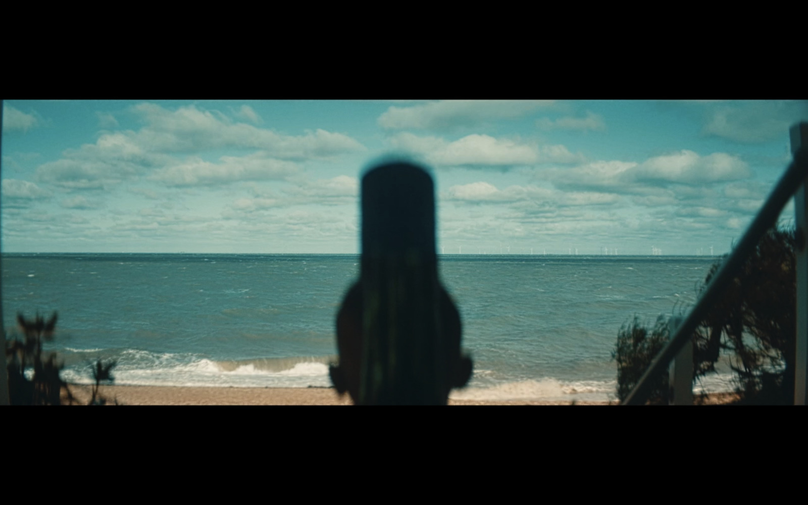 a person standing on a beach looking out at the ocean