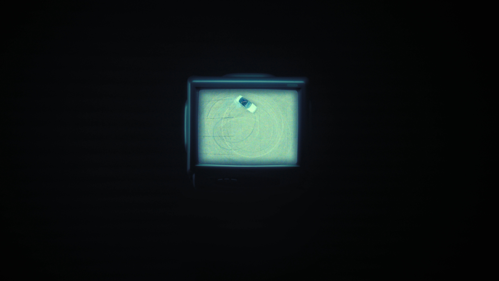 an old television in the dark with a circular design on the screen