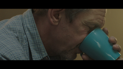 a man drinking out of a blue cup