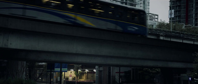 a train traveling over a bridge in a city