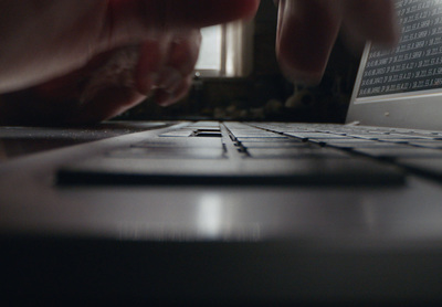 a close up of a person typing on a laptop