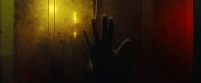 a person's hand reaching out of a window