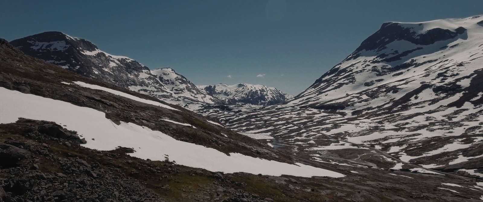 a view of a snow covered valley with mountains in the background