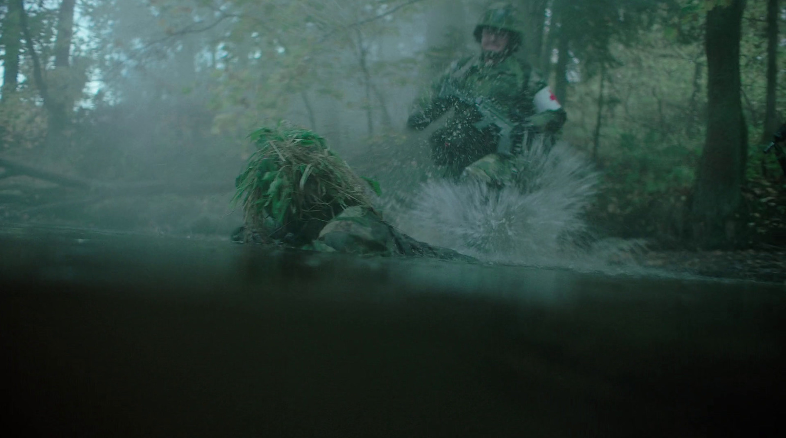 a man riding on the back of a motorcycle through a forest