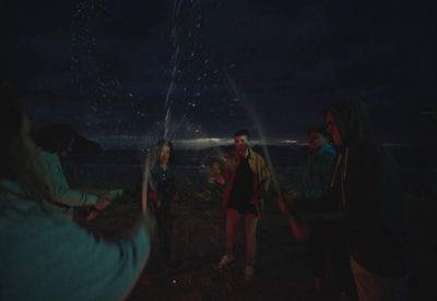 a group of people standing around a firework