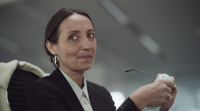 a woman sitting in a chair holding a toothbrush