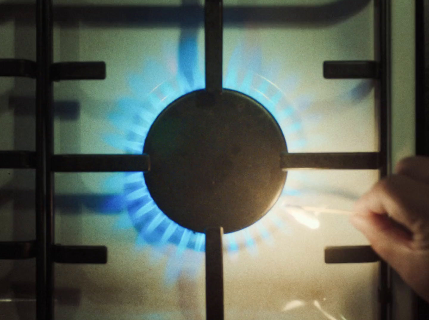 a person is touching a burner on a stove