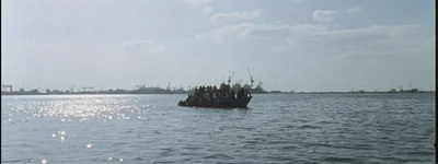 a small boat floating on top of a large body of water