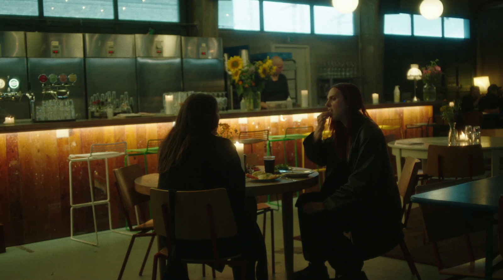 two women sitting at a table in a restaurant