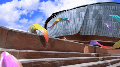 a large building with a bunch of colorful kites in front of it