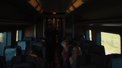 a group of people sitting on a bus in the dark