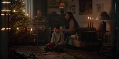 a family sitting around a christmas tree in a living room