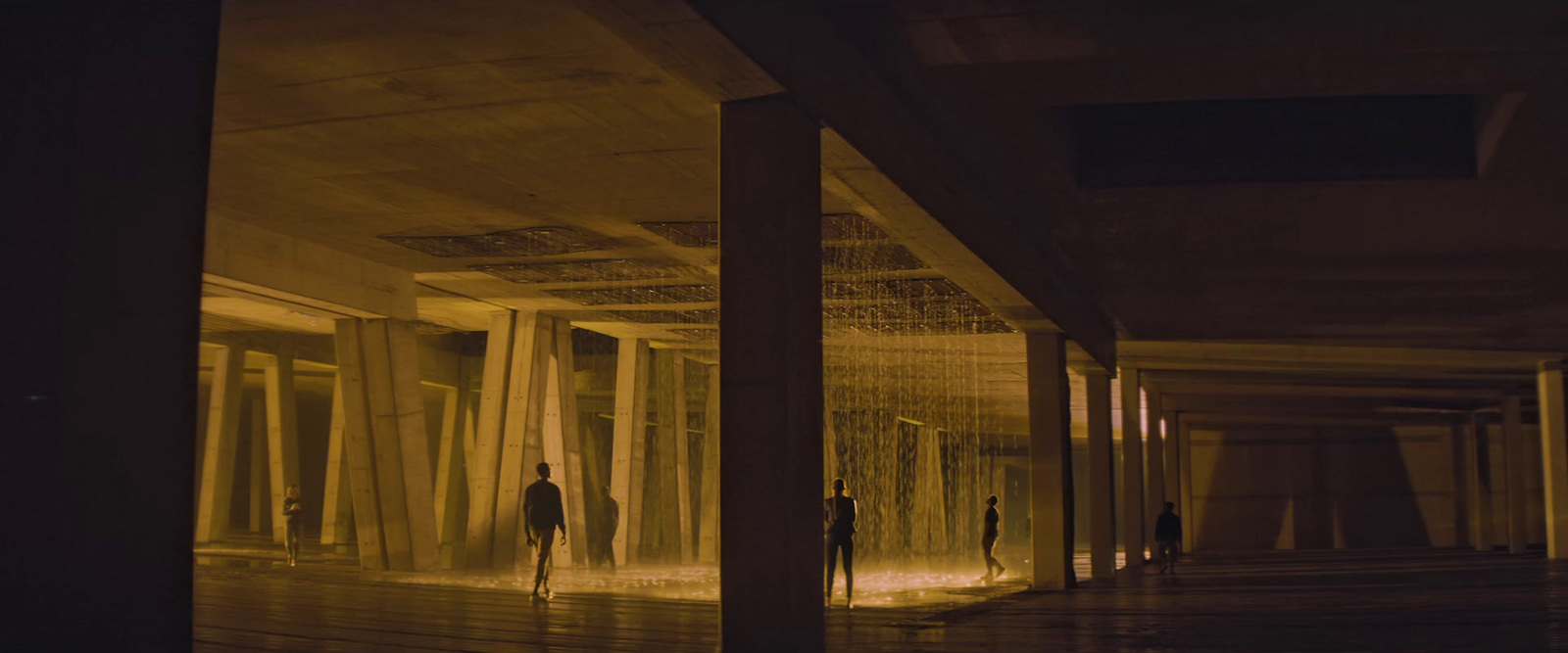 a group of people walking down a hallway in a building