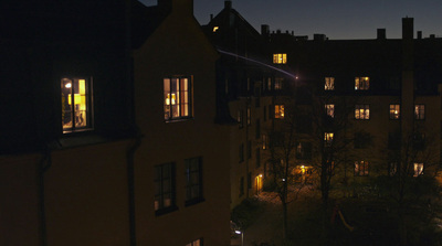 a night time view of a building with a lot of windows