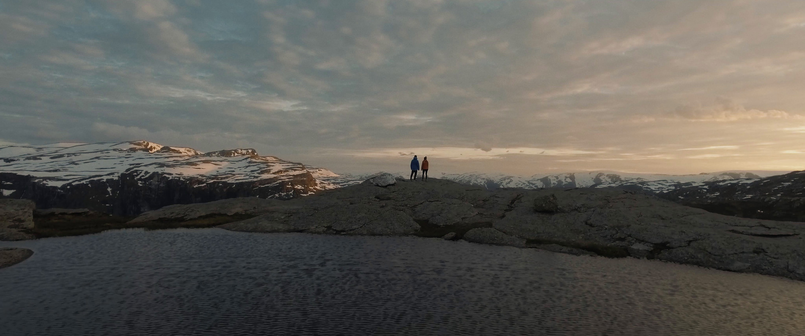 a person standing on top of a snow covered mountain