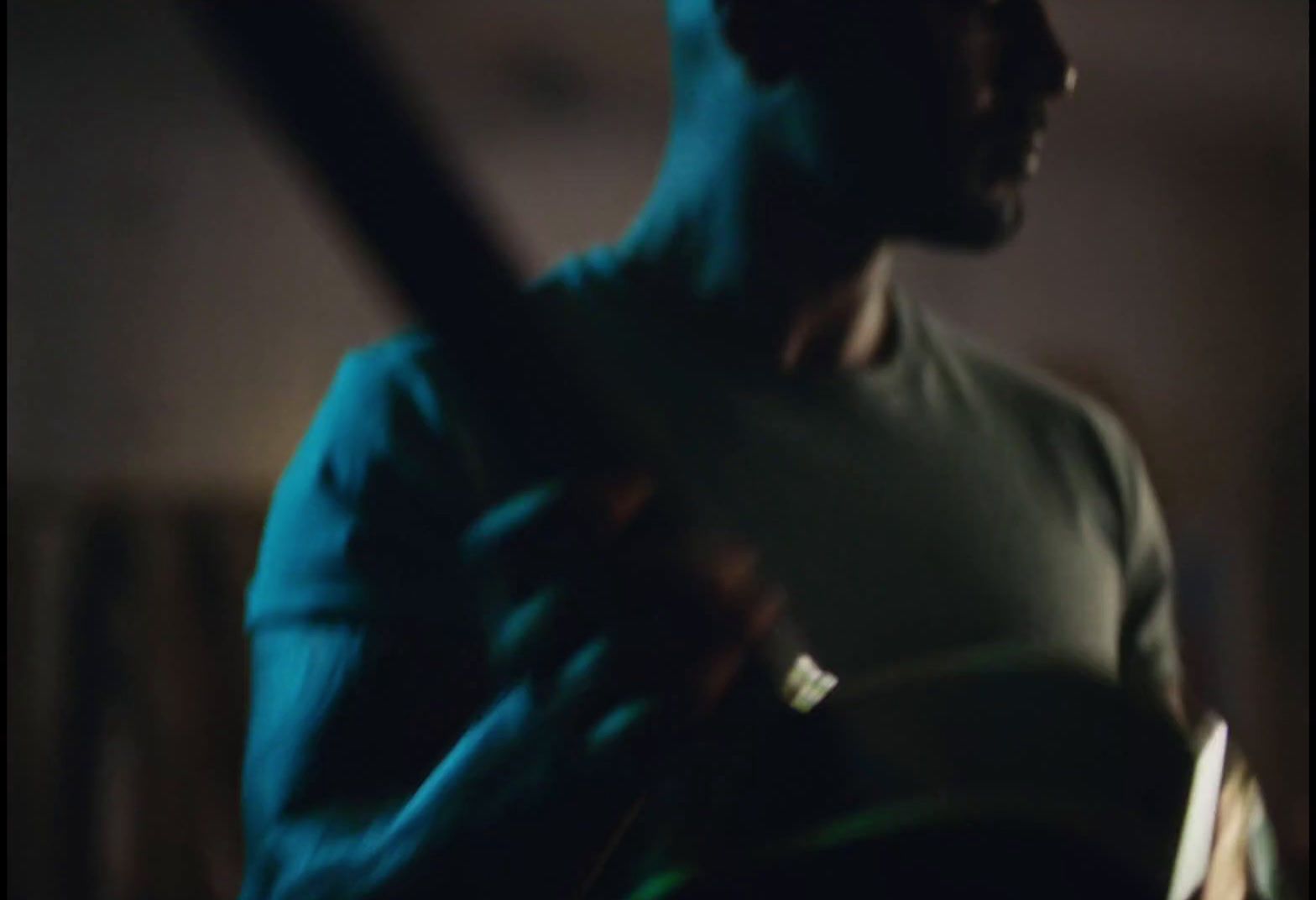 a man playing a guitar in a dark room