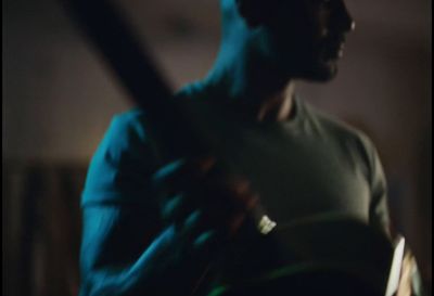 a man playing a guitar in a dark room