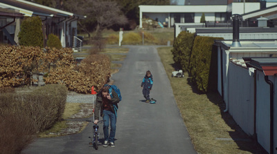 a couple of people riding skateboards down a street