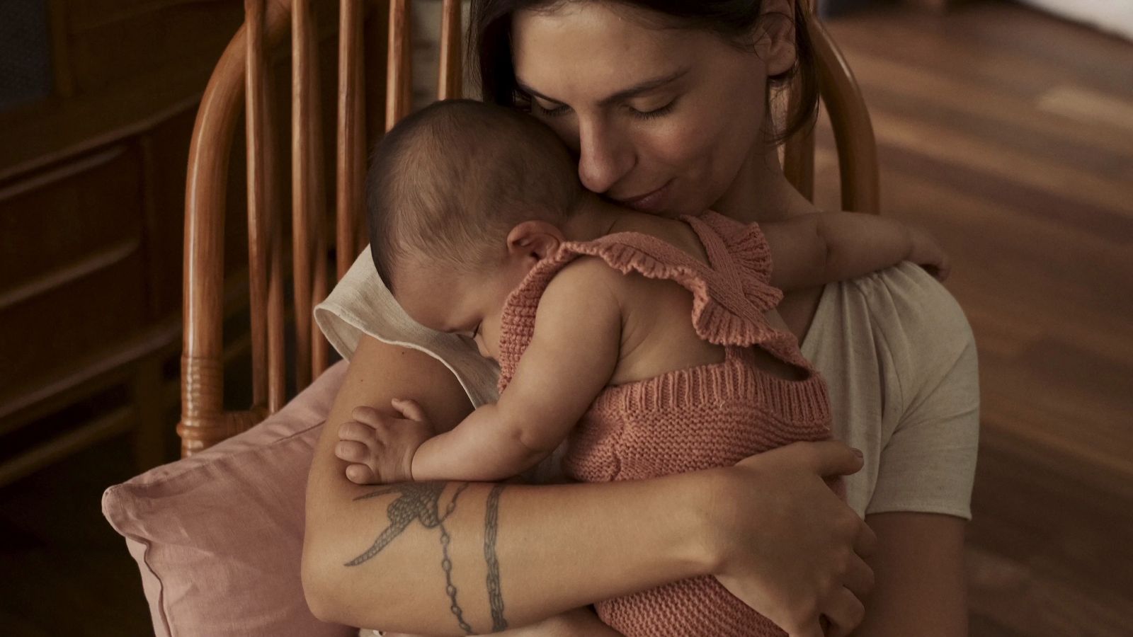 a woman holding a baby in her arms