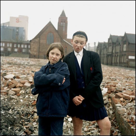 a couple of kids standing next to each other