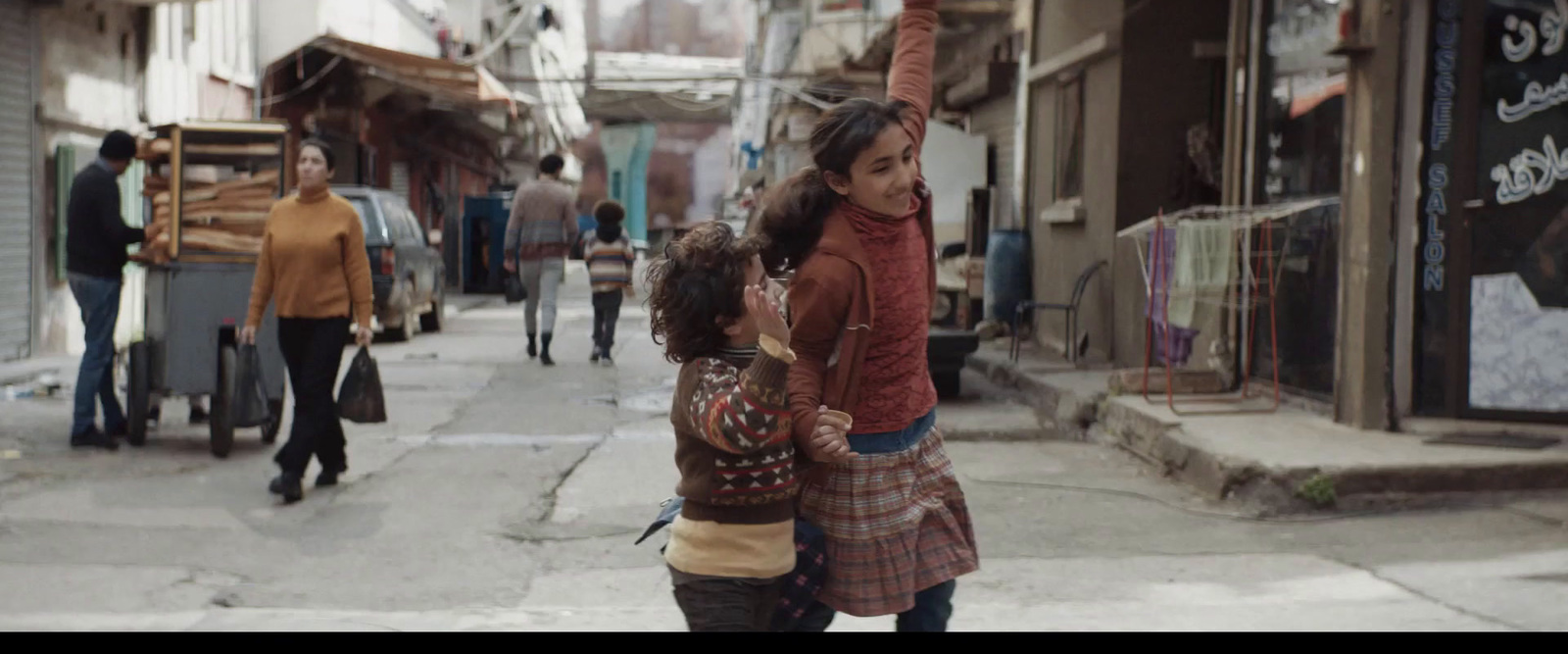 two young girls walking down a city street