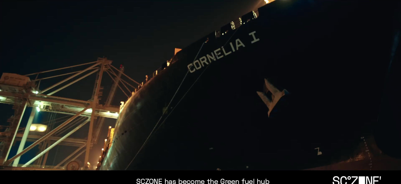 a large ship is docked at night with lights on