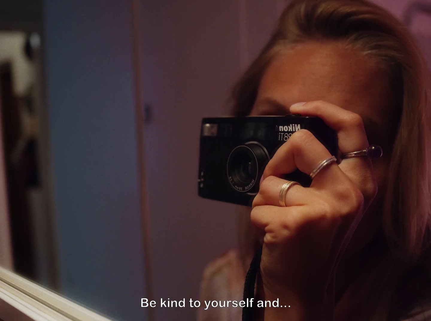 a woman taking a picture of herself in a mirror