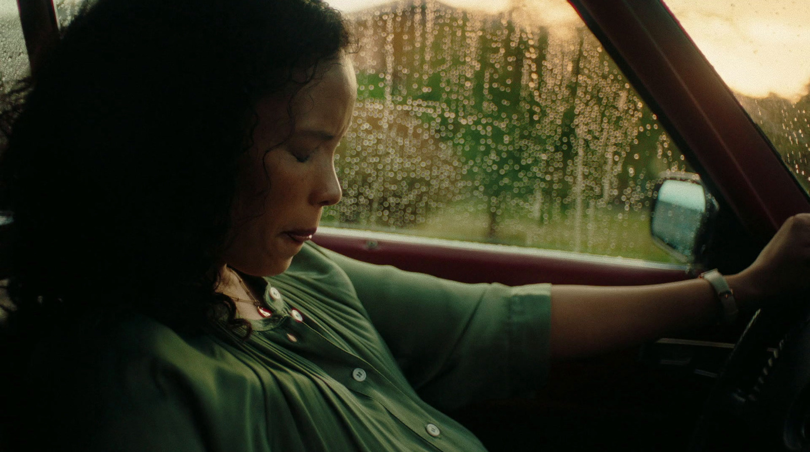 a woman driving a car in the rain