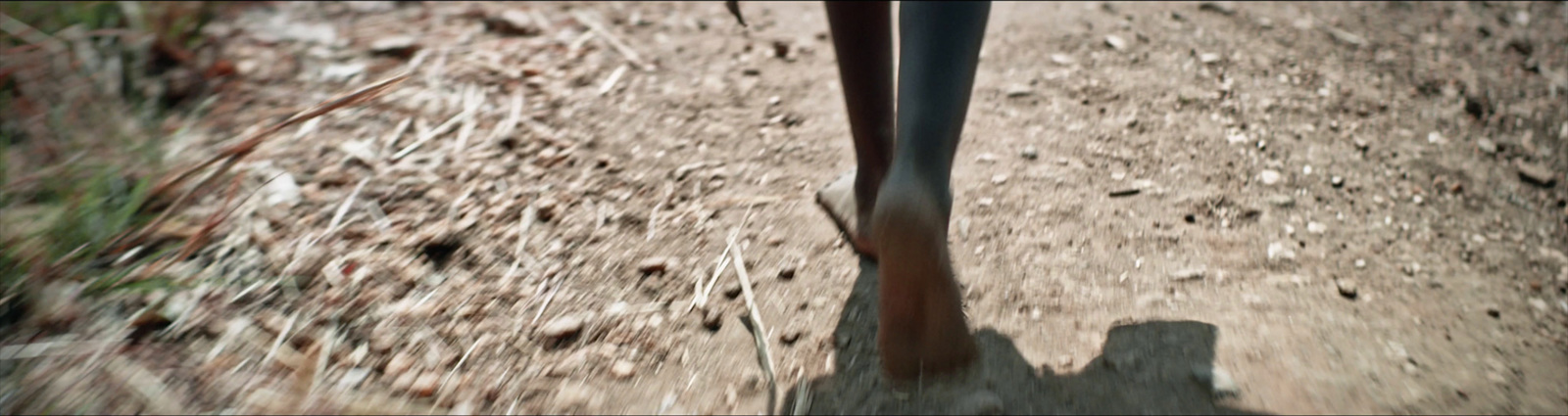 a person riding a bike down a dirt road