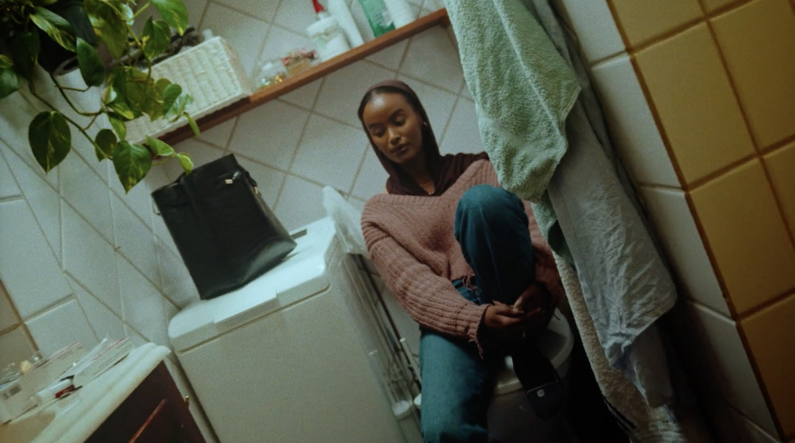 a woman sitting on a toilet in a bathroom