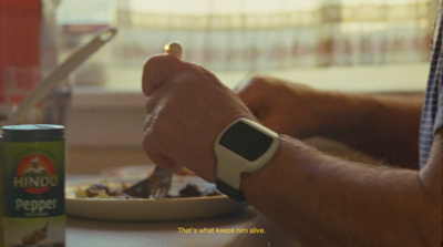 a man is eating a meal with a smart watch on his wrist