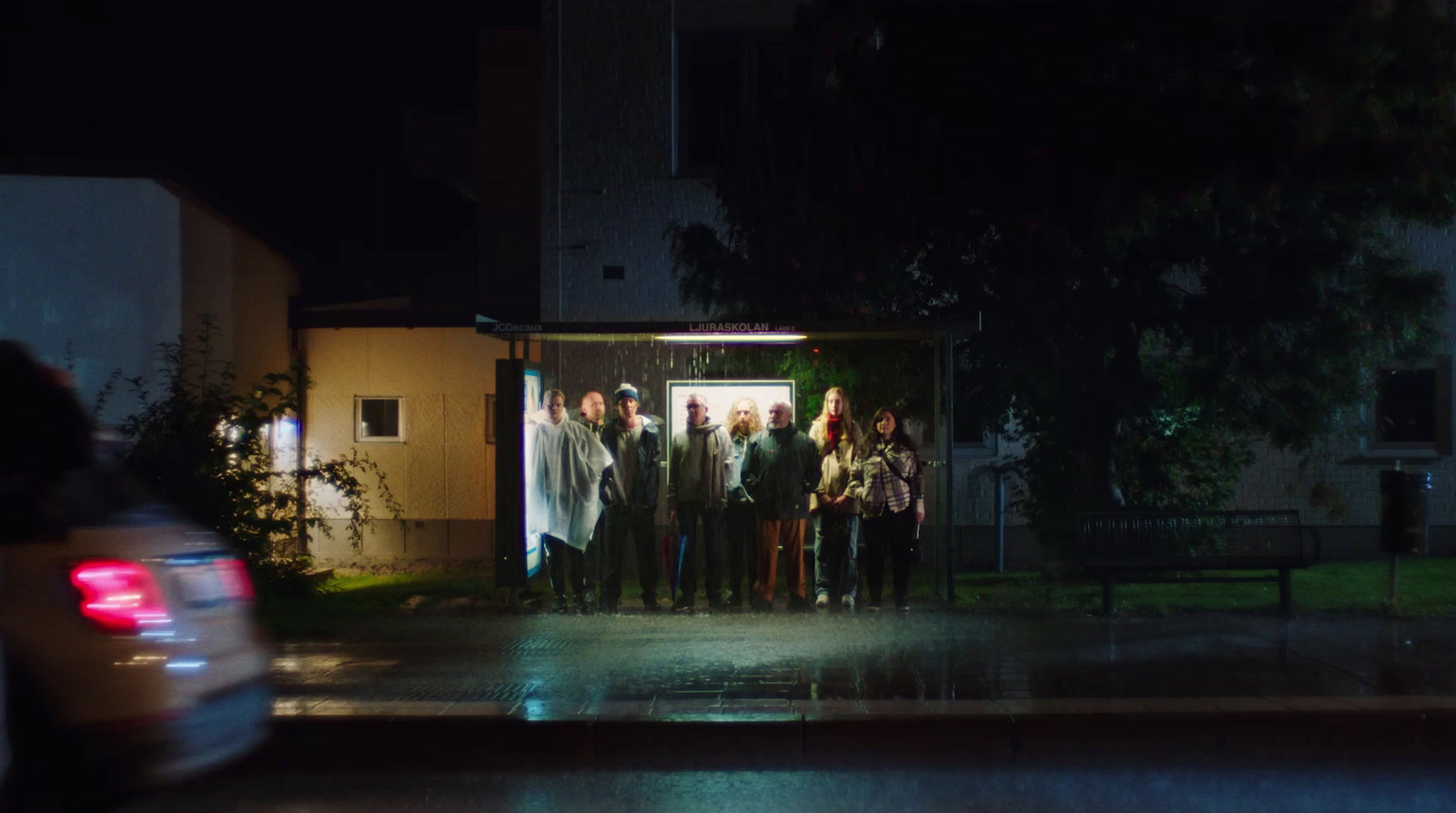 a group of people standing in front of a building at night